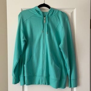 Light teal zipper up hooded sweatshirt.